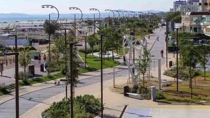Lungomare con piste ciclabili, alberi e lampioni vicino alla spiaggia
